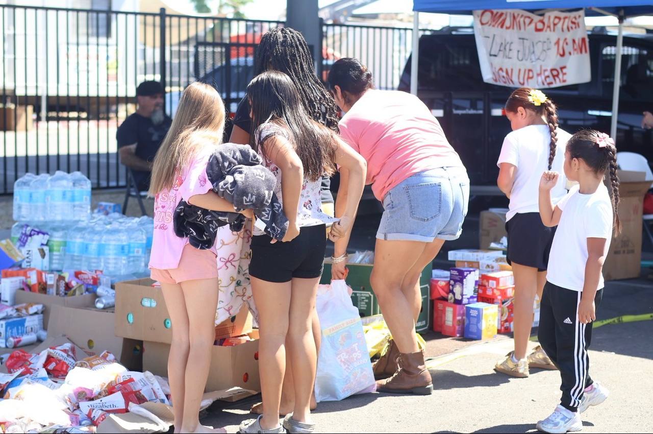 Volunteers at a table of food and supplies