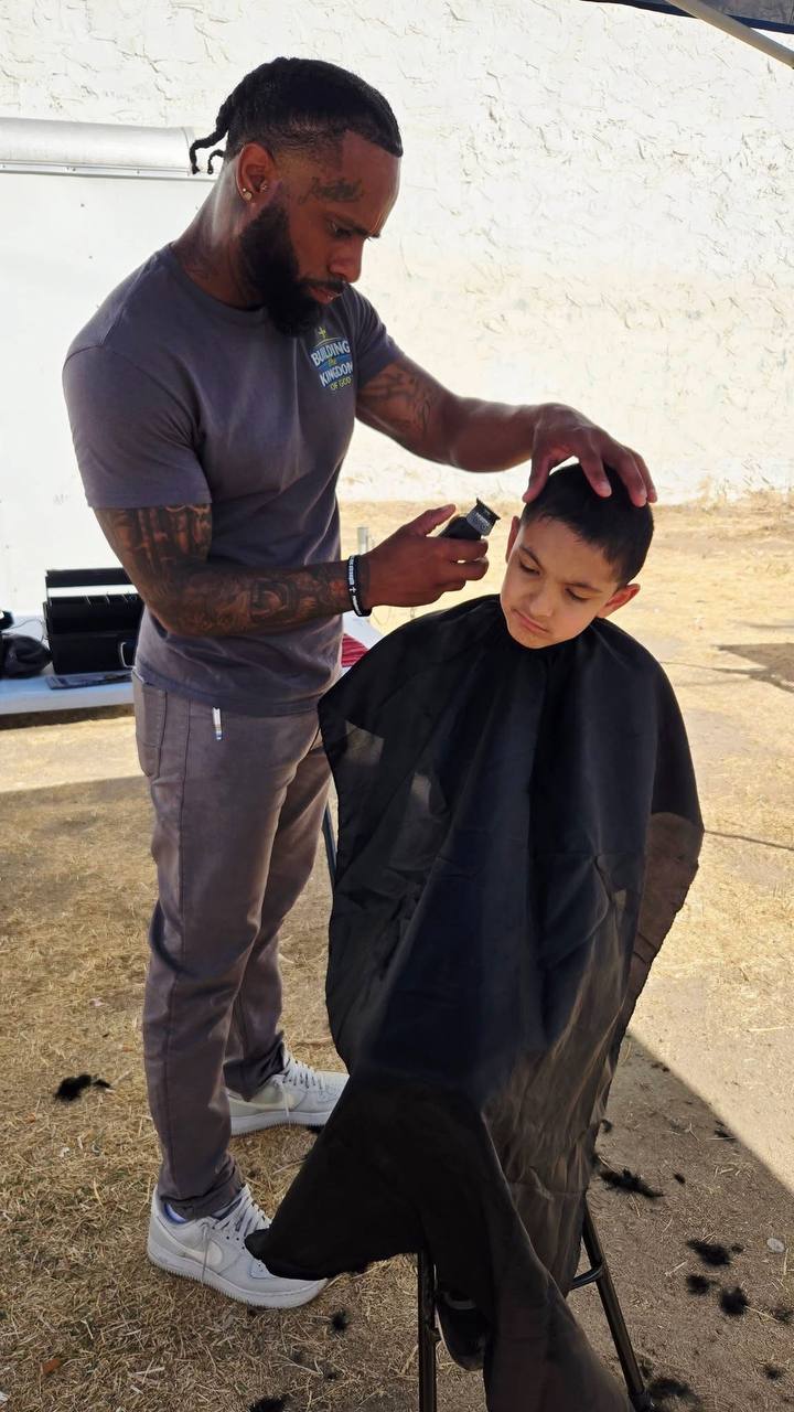 A volunteer barber giving a child a haircut