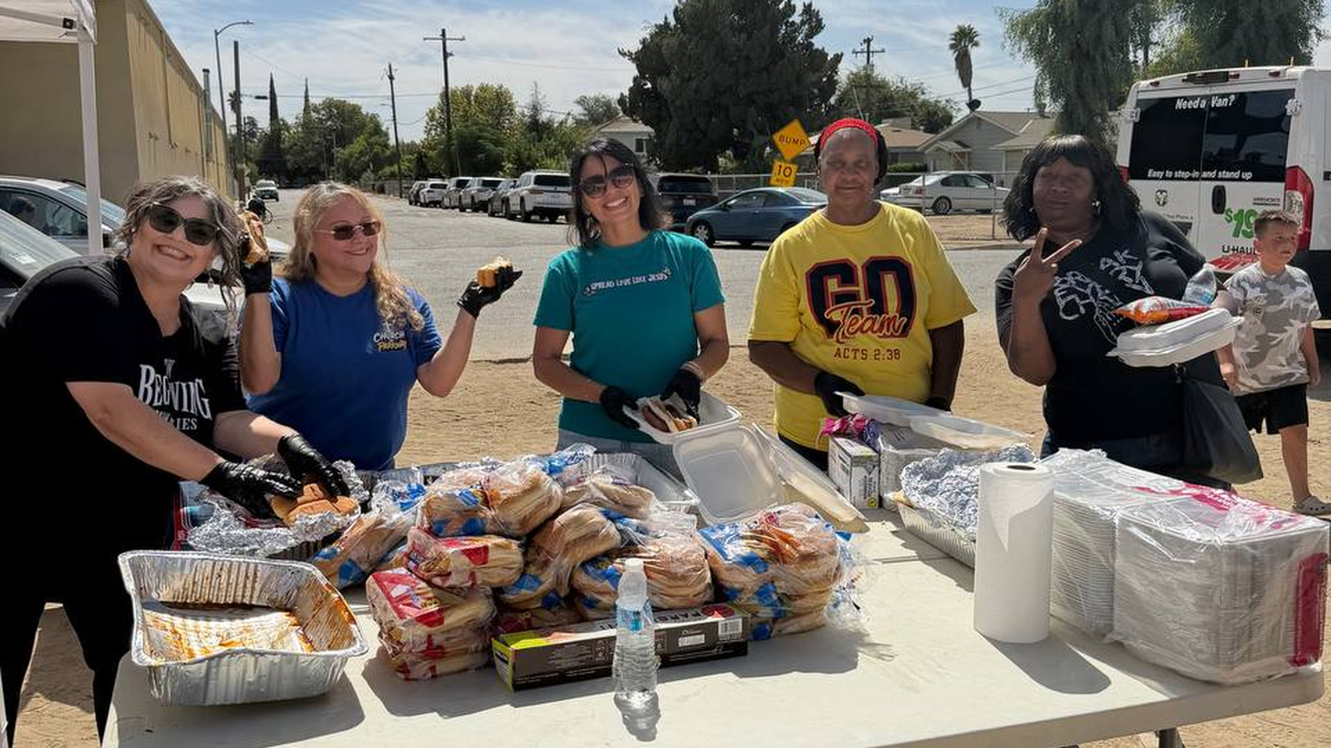 Volunteers serving food at a God Over Everything outreach